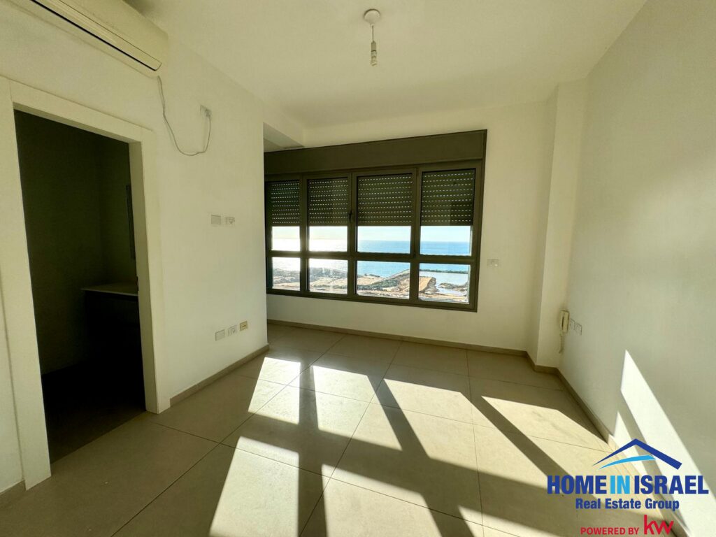 Luxurious primary bedroom suite in Vista Tower Netanya with floor-to-ceiling windows and sea view.