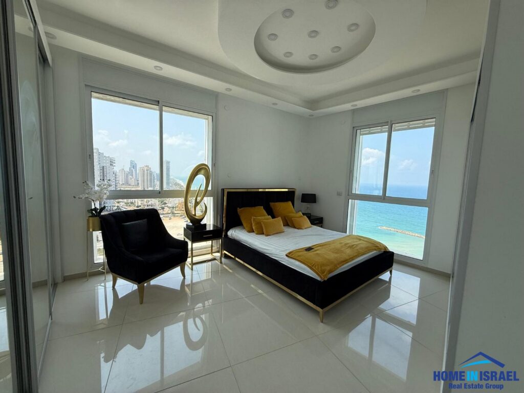 Master bedroom with floor-to-ceiling windows and sea view in Netanya.