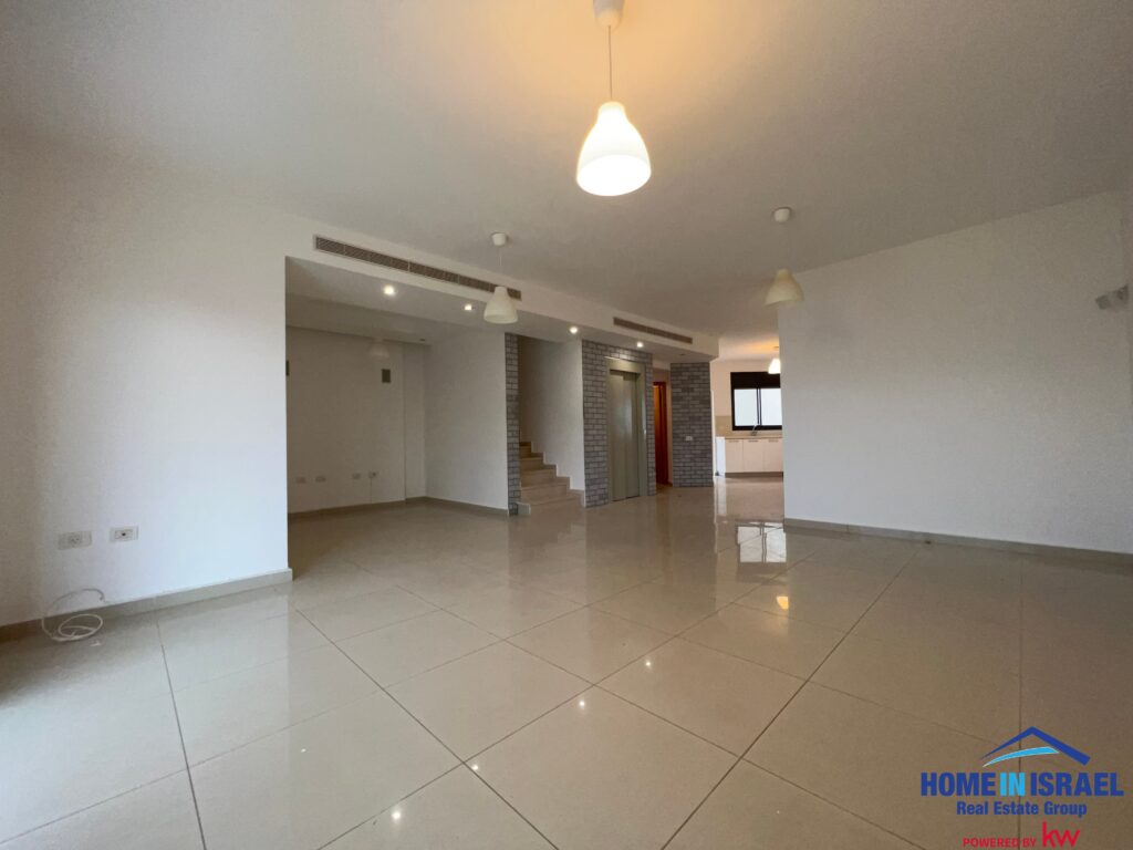 Spacious open-plan living area with liftt and staircase in a luxury home in Netanya.