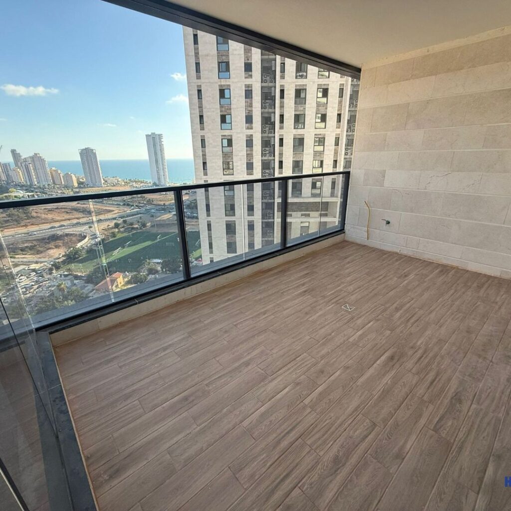 Sun balcony with glass railing overlooking sea promenade — Lipkin-Shahak