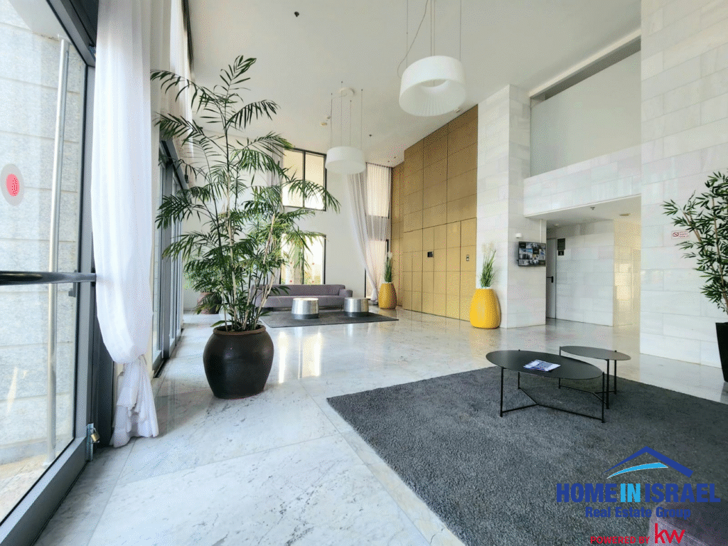 Grand entrance lobby with high ceilings, marble floors and large plants