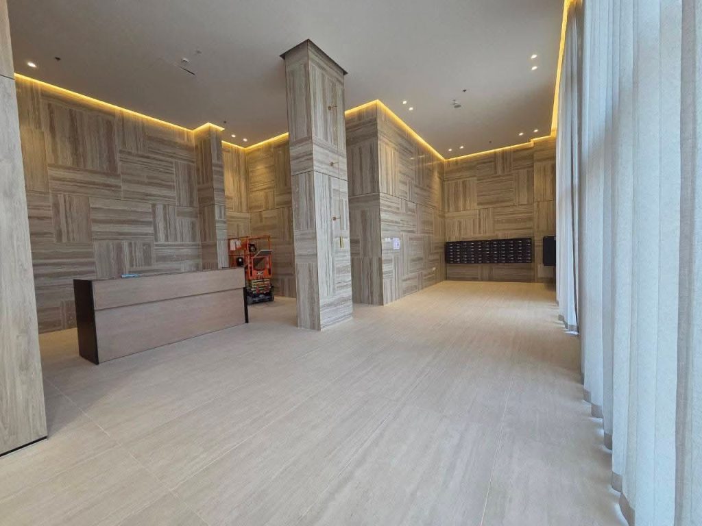 Modern architectural exterior of the Rotem Shani tower at Herzog 6 Netanya with luxury lobby entrance.